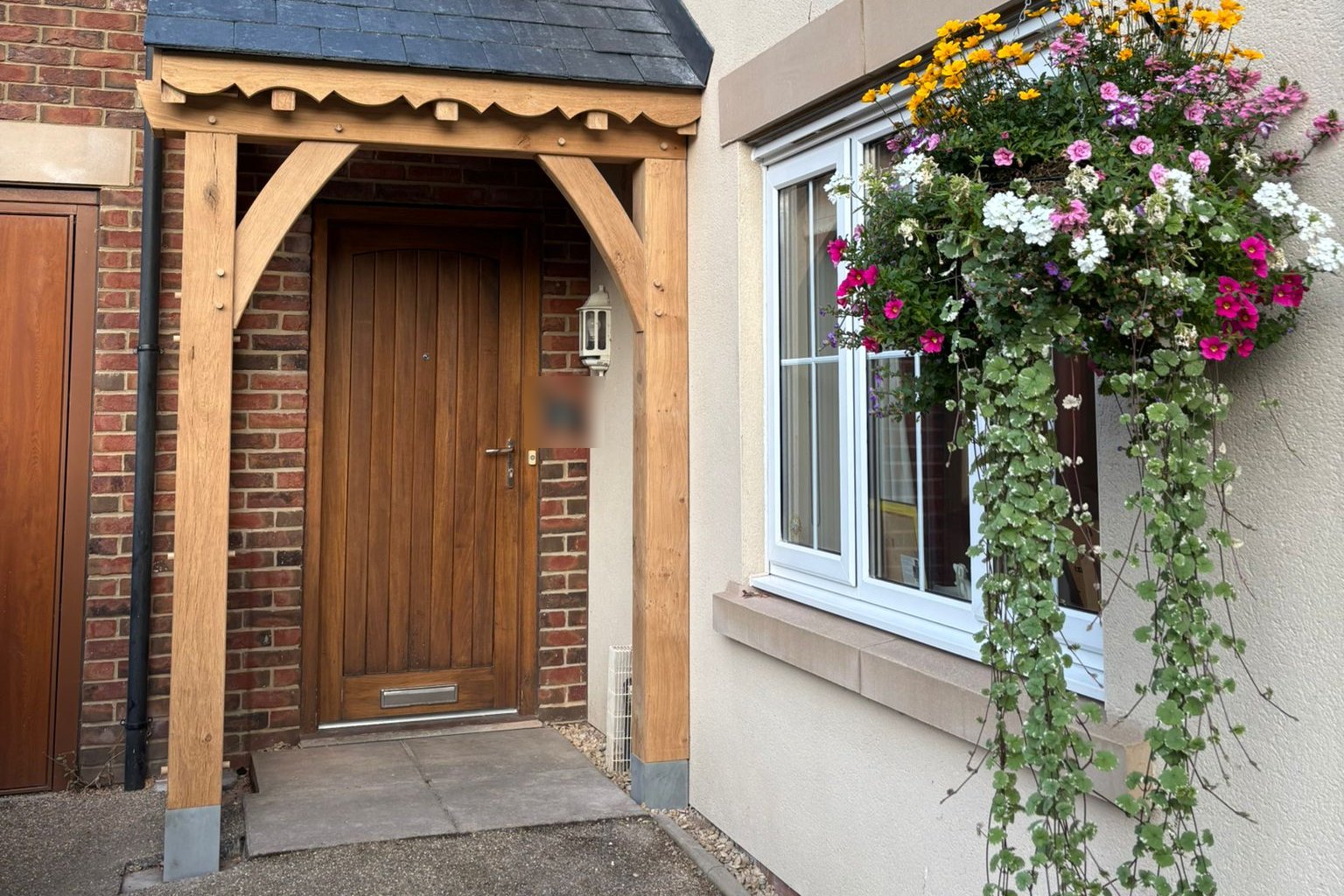 Oak porch with a scalloped bargeboard and slate roof at Usk