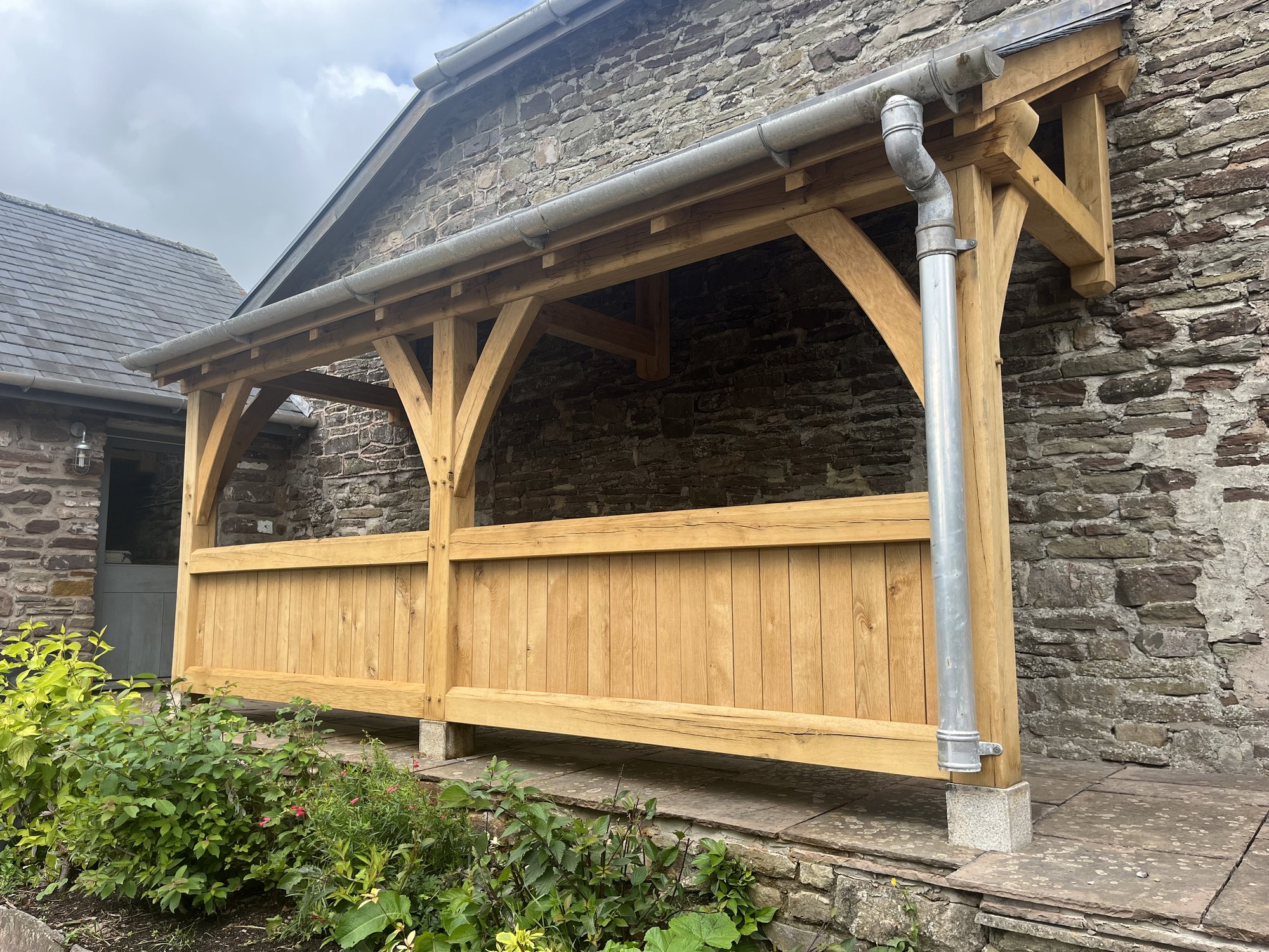 The oak veranda at Llanvetherine at an angle, with its slate roof
