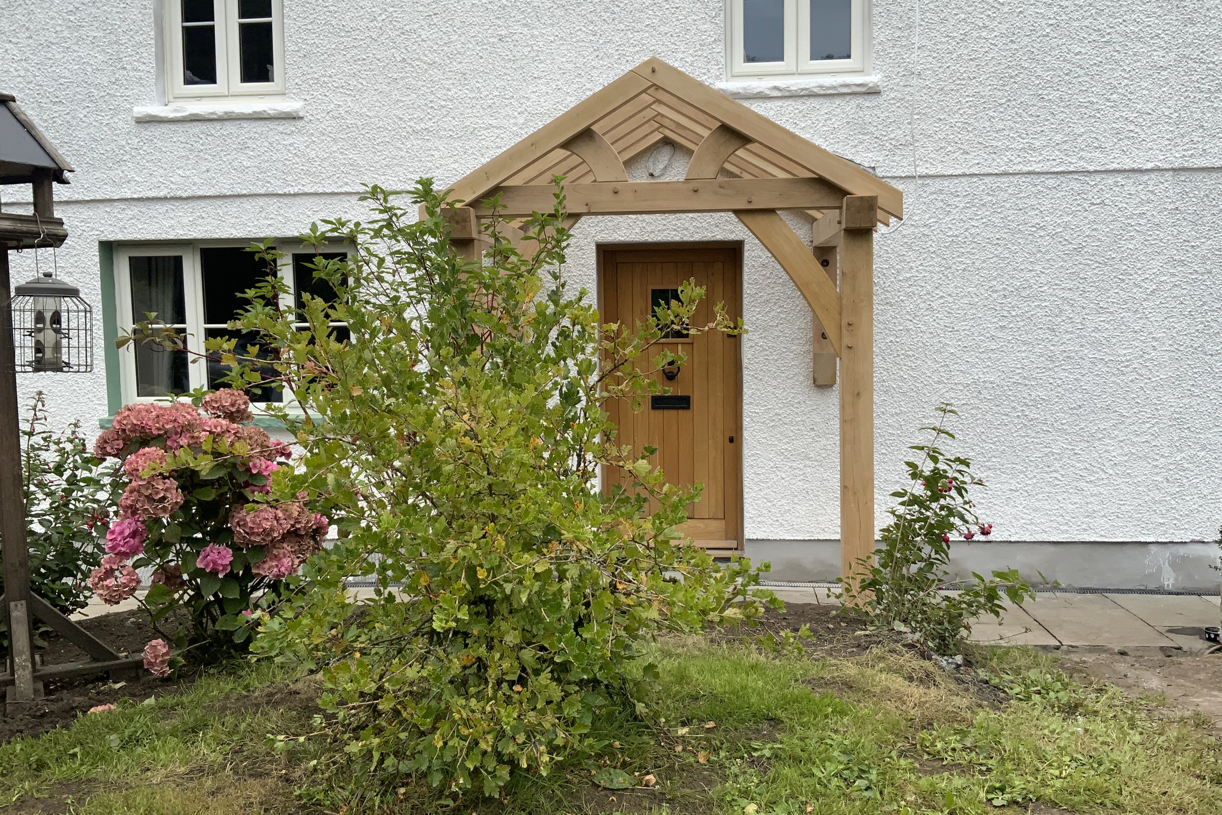 Oak gable porch on a white rendered cottage
