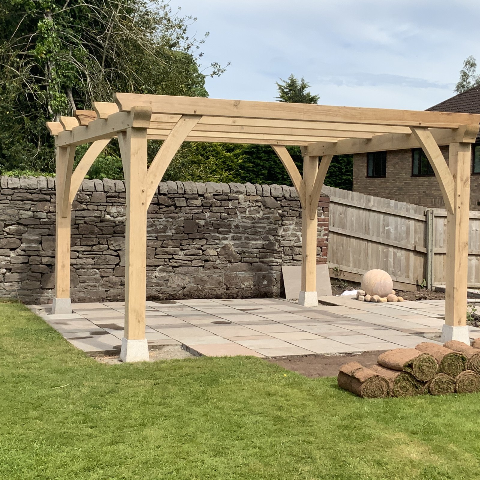 Freestanding oak pergola on a paved terrace