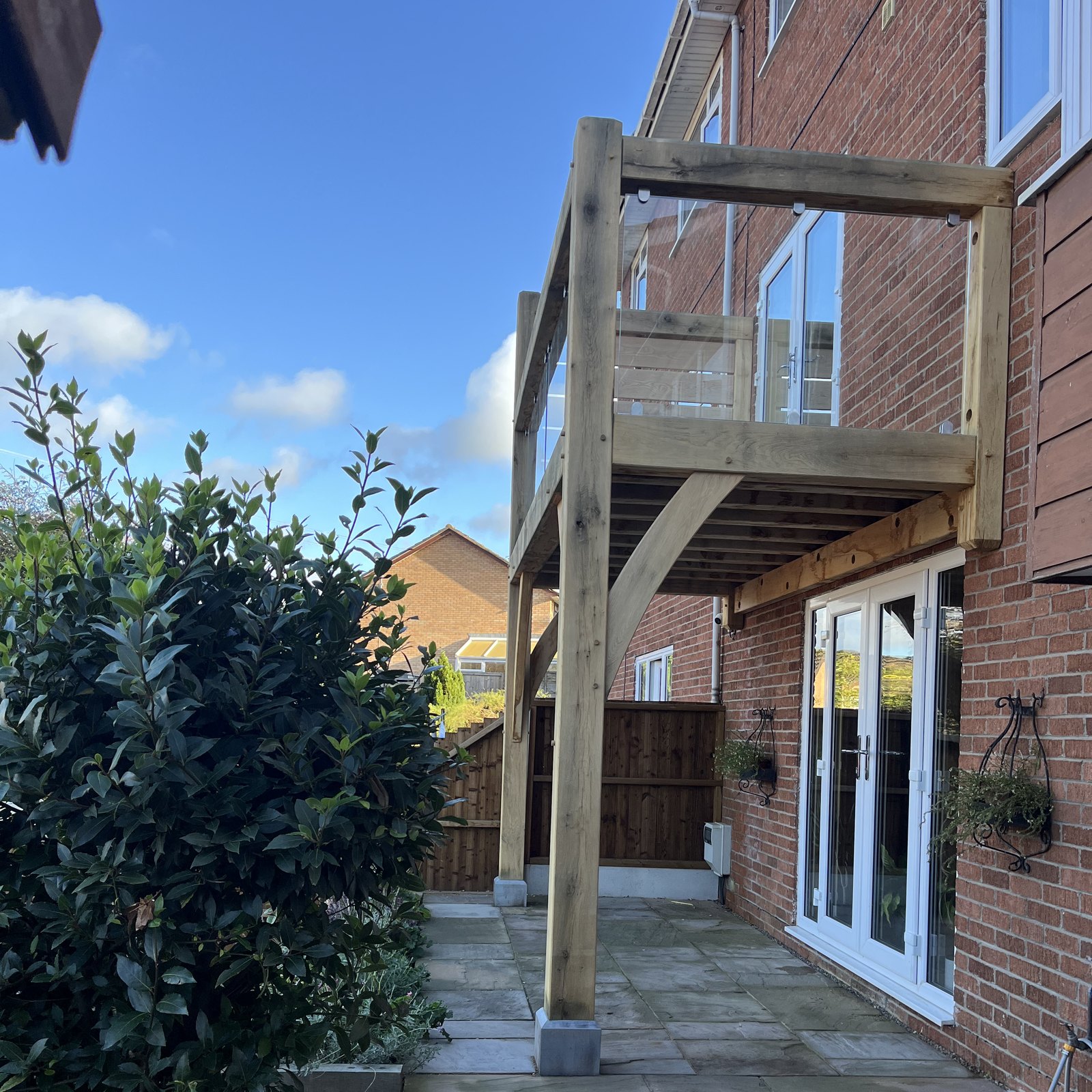 Oak balcony post and braces beside the patio doors