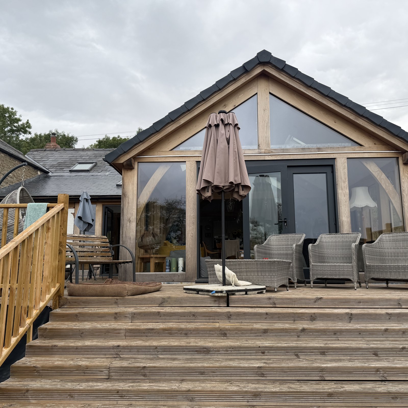 Glazed oak gable of a garden room above a timber deck