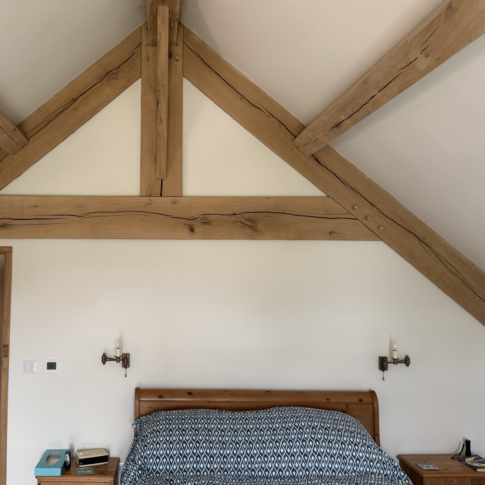 Oak truss and vaulted ceiling above a bedroom