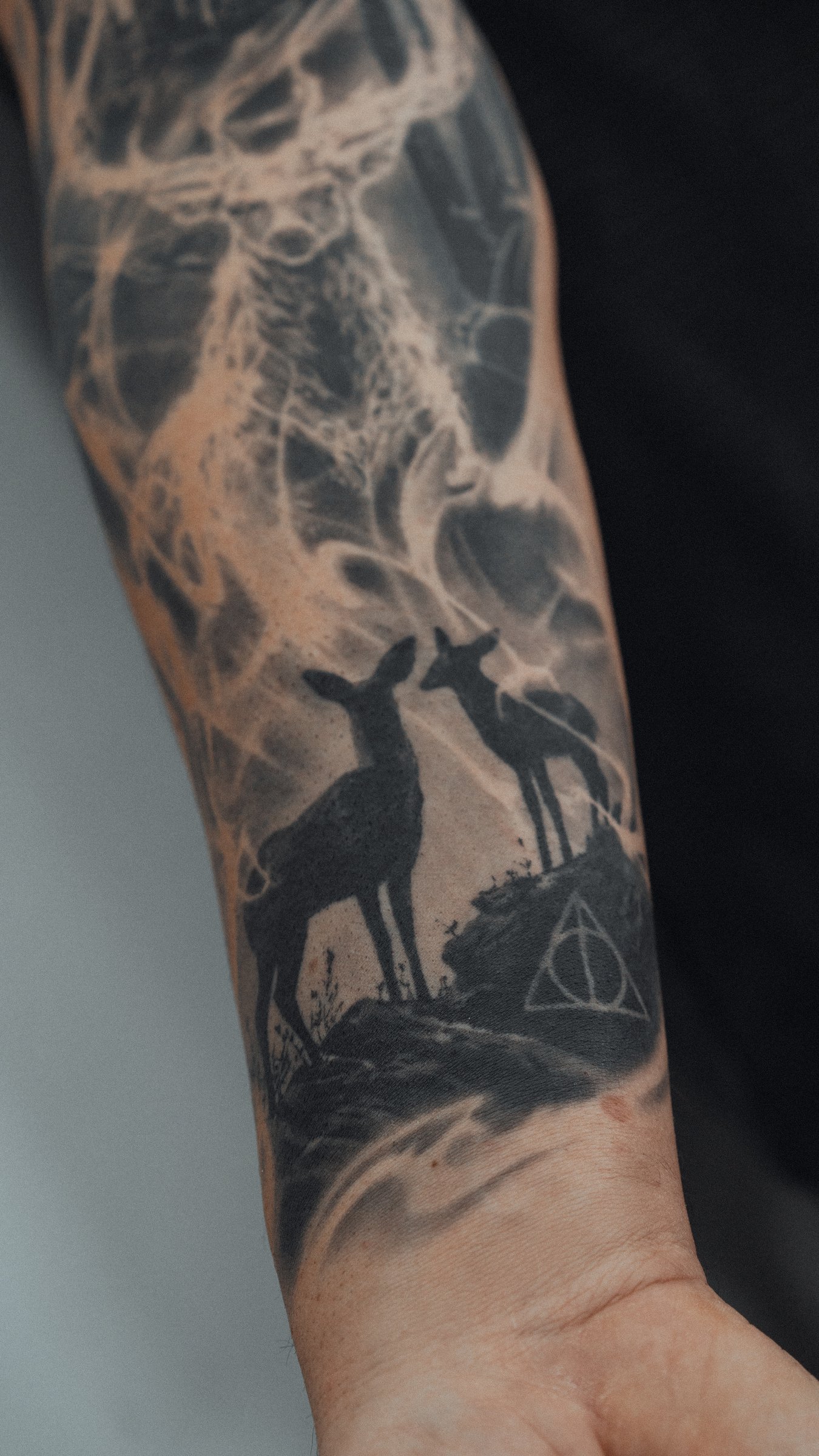 Two deer and Deathly Hallows symbol — wrist detail, Harry Potter sleeve tattoo by AMP ART Munich
