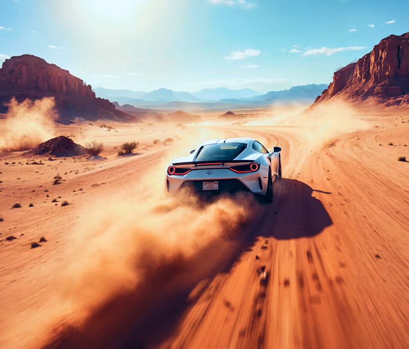 White sports car driving fast on dusty desert road between rocky mountains under bright sky.