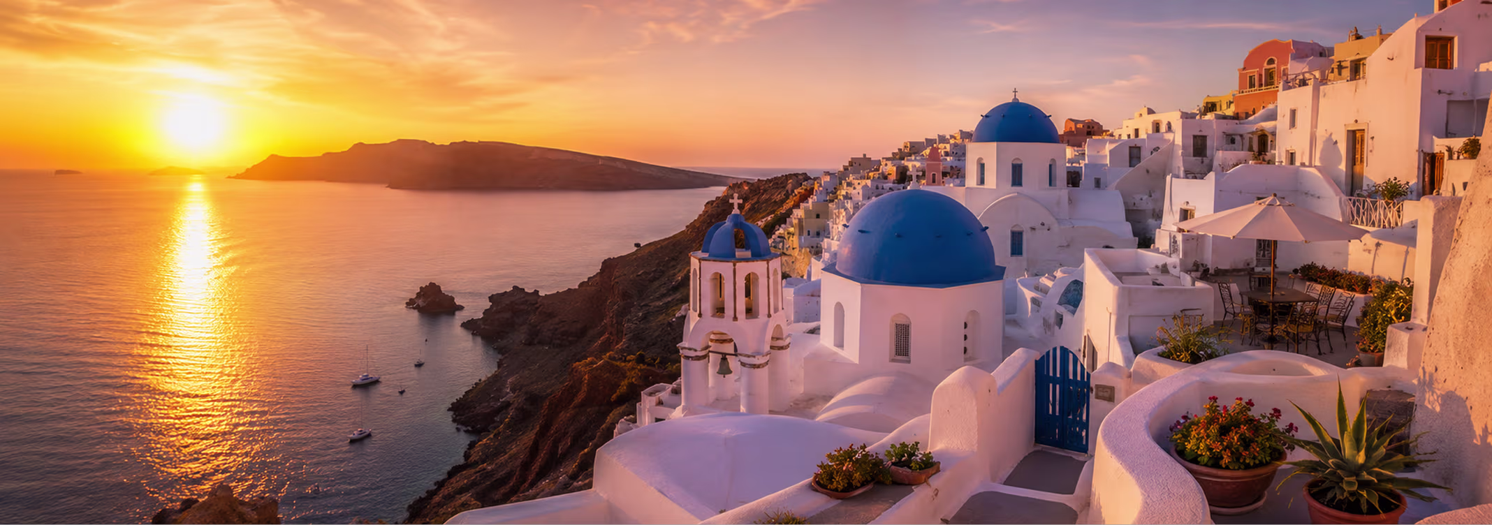 Couple watching sunset over Santorini caldera