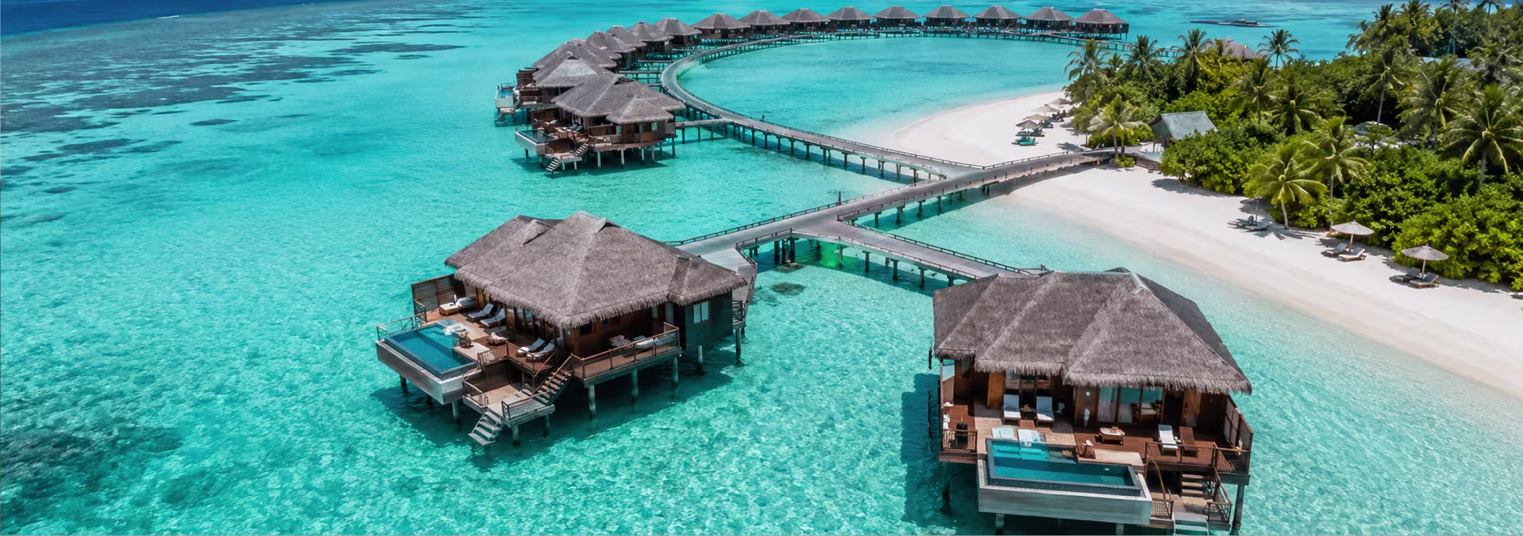 Aerial view of Maldives overwater villas and turquoise lagoon