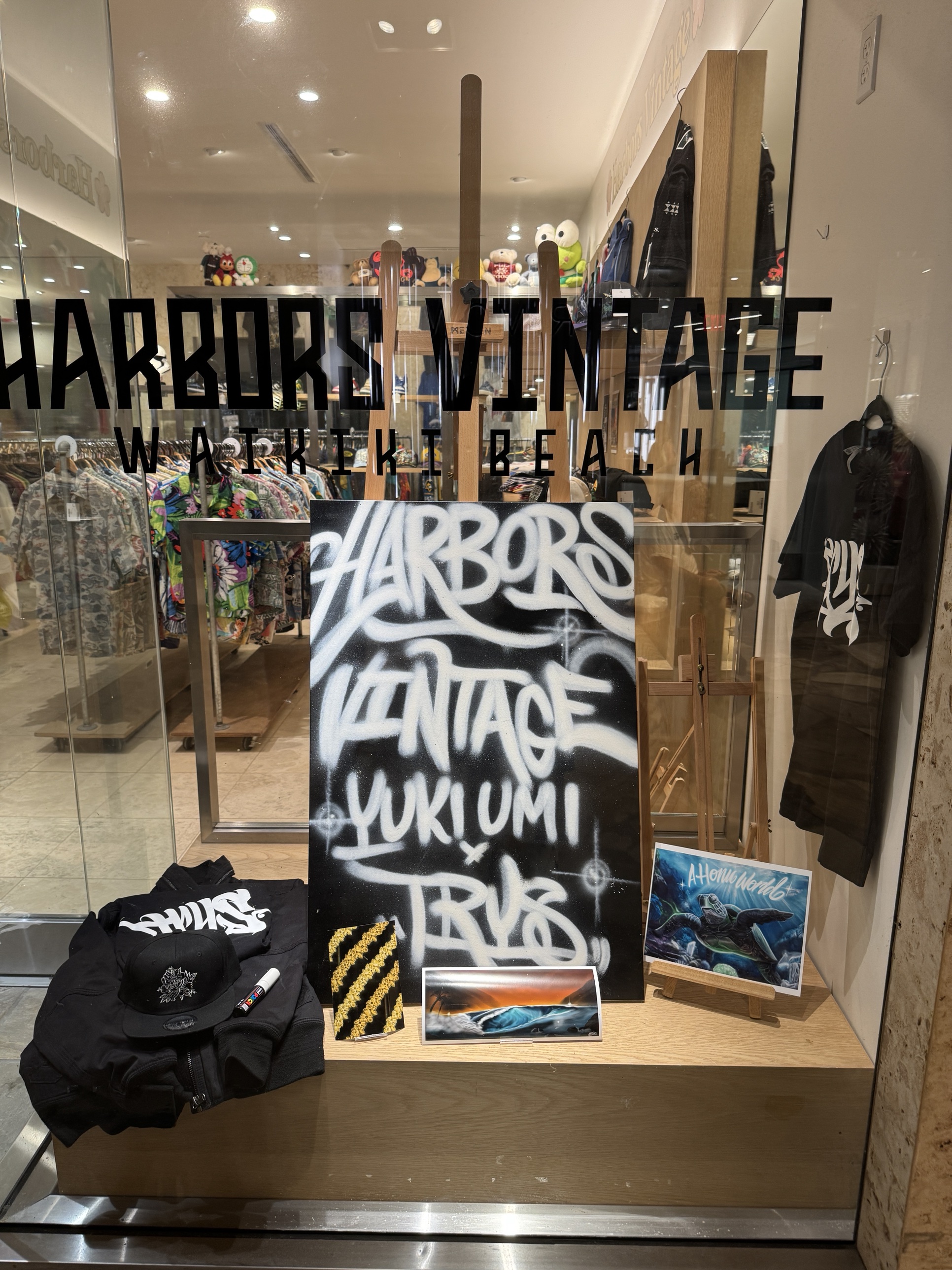 TRYS window display at Harbors Vintage with the lettered sign, prints, hats and merch