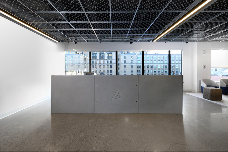 Custom reception desk in concrete and walnut veneer
