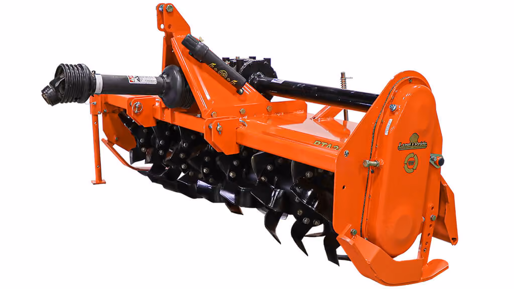 Orange rotary tiller attachment for breaking up soil on a white studio background.