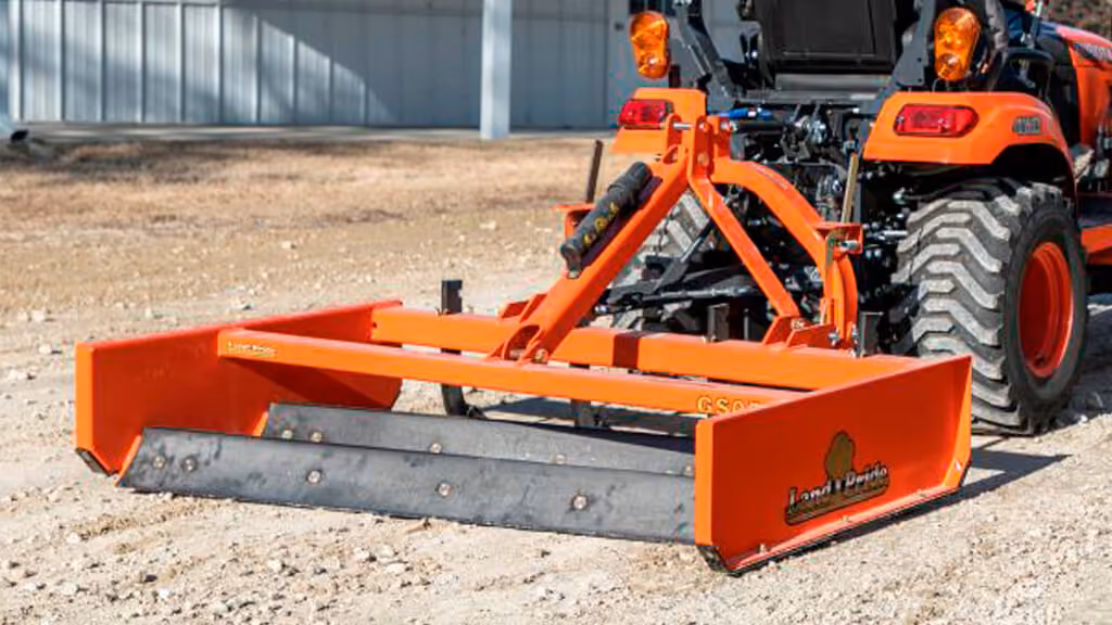 Orange grading attachment with wide steel blade.
