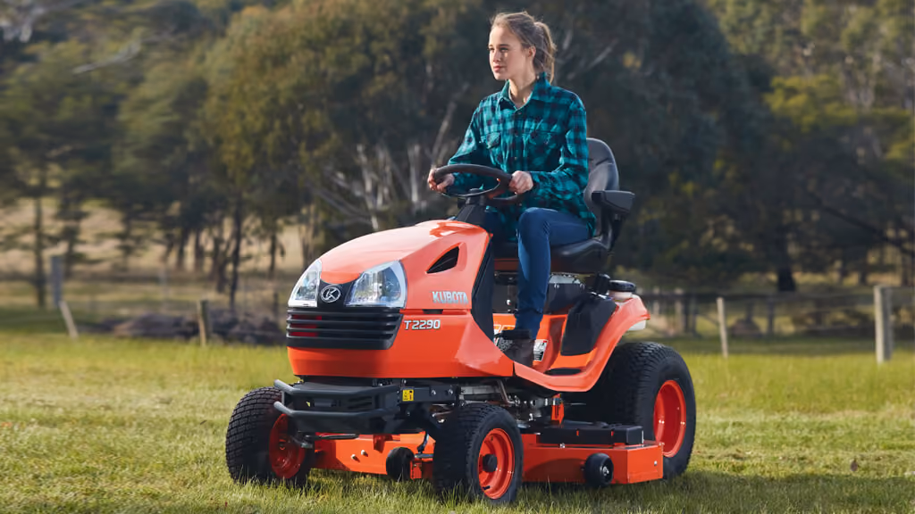 Orange Kubota mower with cutting deck.