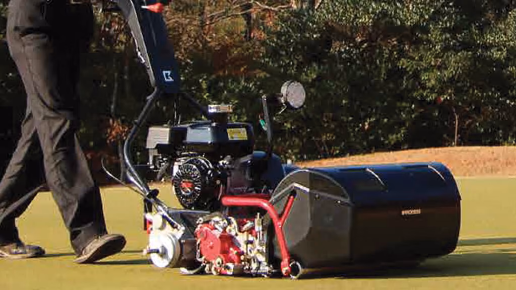 Orange Kubota mower with cutting deck.