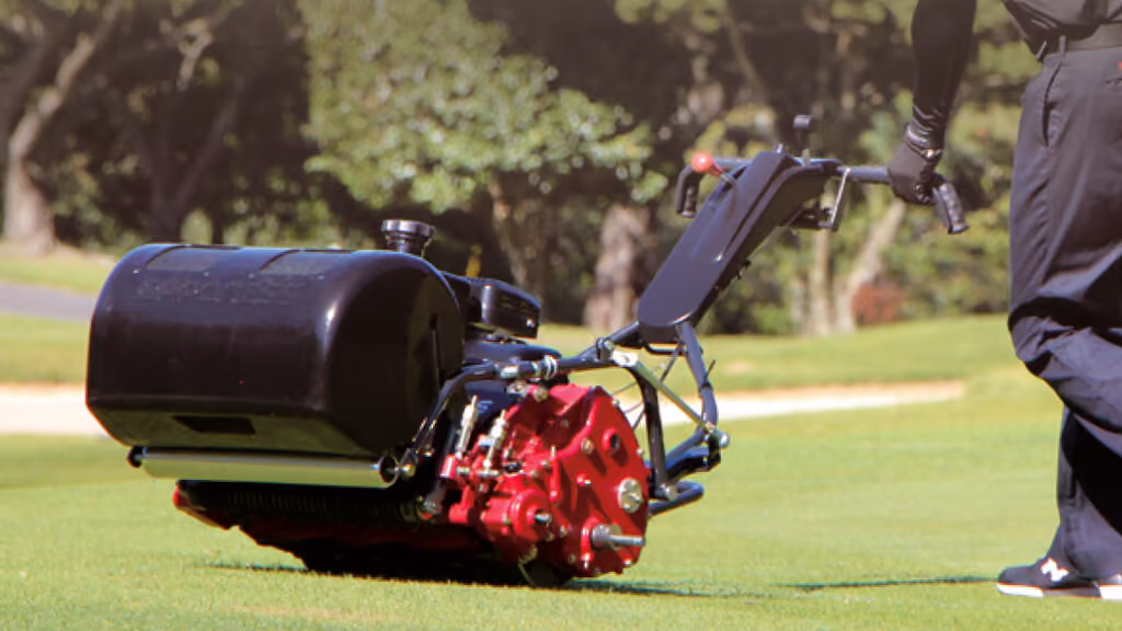 Orange Kubota mower with cutting deck.