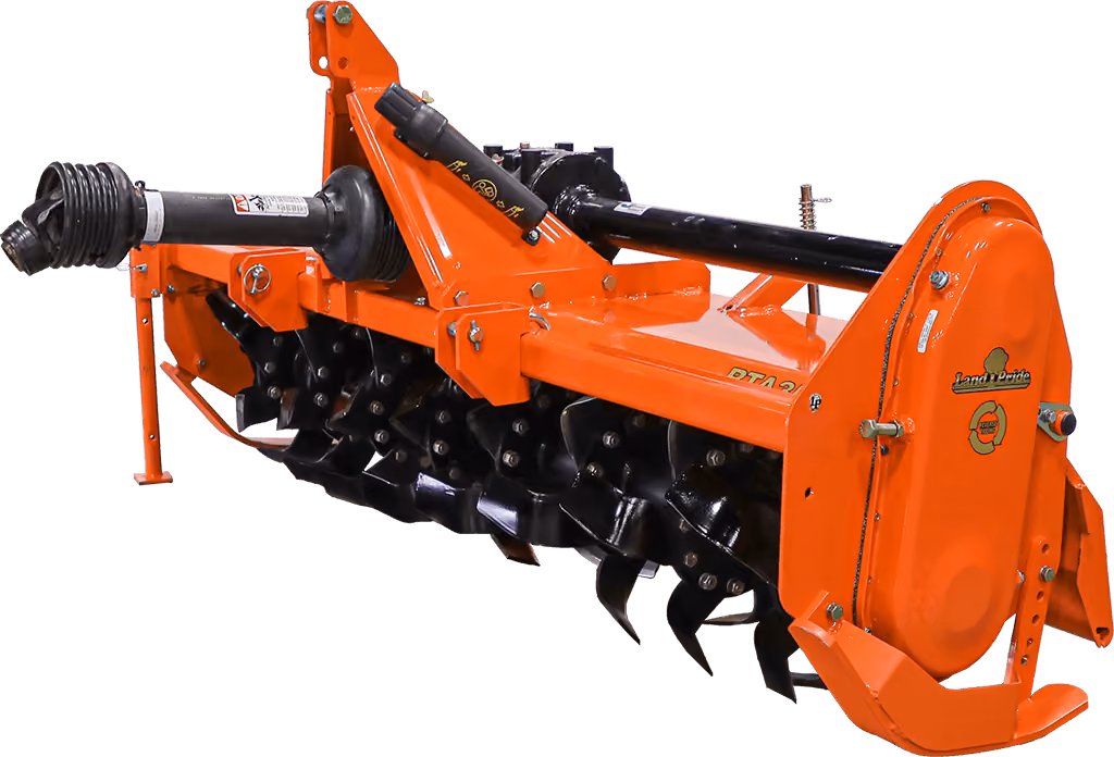 Orange rotary tiller attachment for breaking up soil on a white studio background.