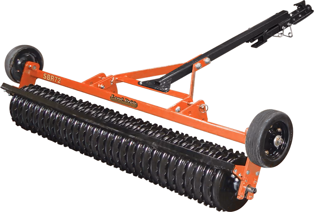 Orange seeder attachment for preparing and planting soil on a white studio background.