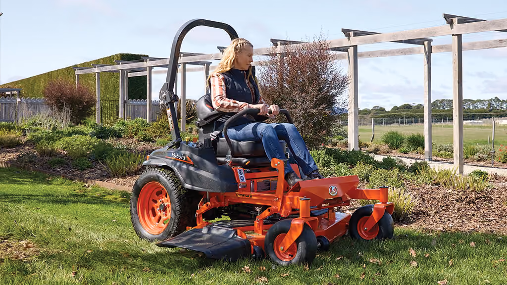 Orange Kubota mower with cutting deck.