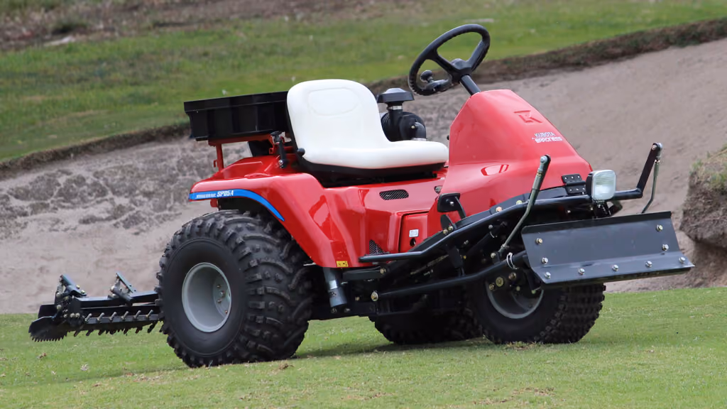 Turf bunker rake machine with rear grooming rake.