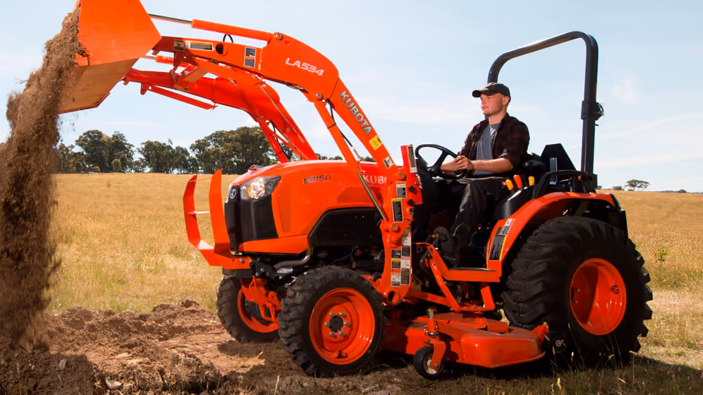 Orange Kubota tractor with roll-over protection.