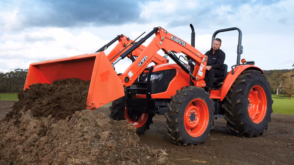 Orange Kubota tractor with roll-over protection.