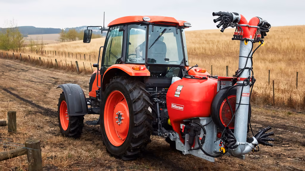 Orange Kubota tractor with roll-over protection.