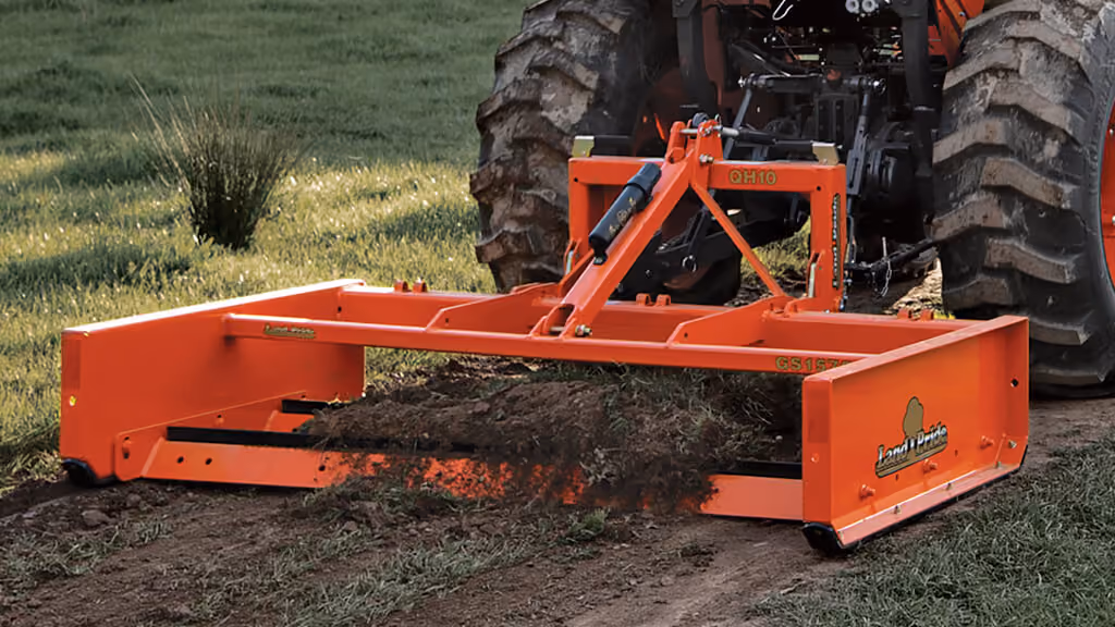 Orange grading attachment with wide steel blade.