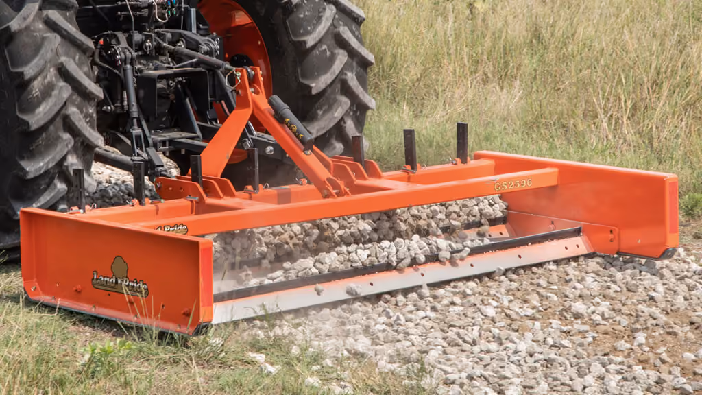 Orange grading attachment with wide steel blade.