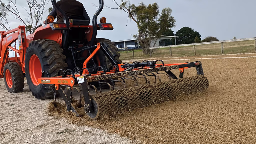 Orange grading attachment with wide steel blade.