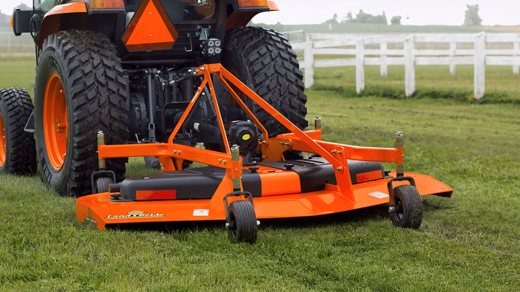 Orange Kubota mower with cutting deck.