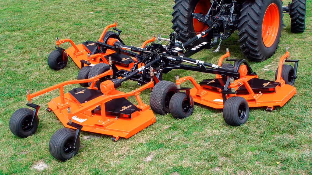Orange Kubota mower with cutting deck.