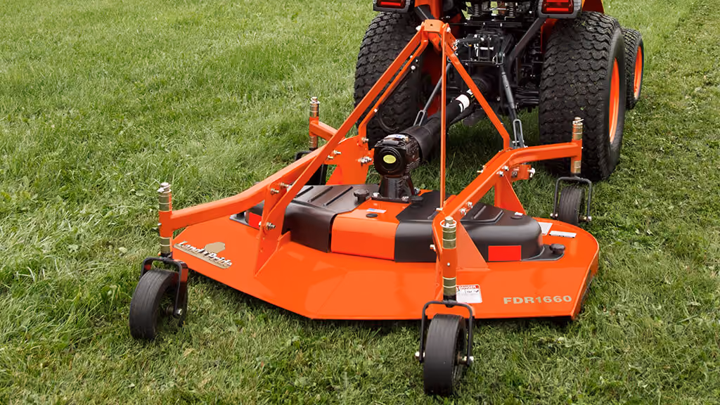 Orange Kubota mower with cutting deck.