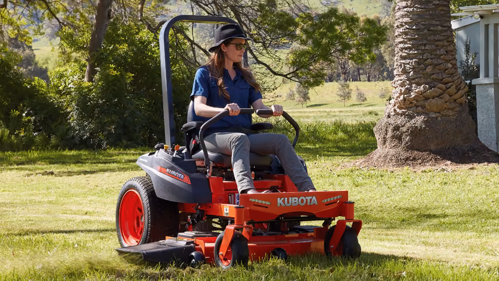 Orange Kubota mower with cutting deck.