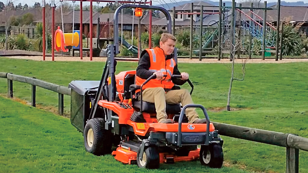 Orange Kubota mower with cutting deck.