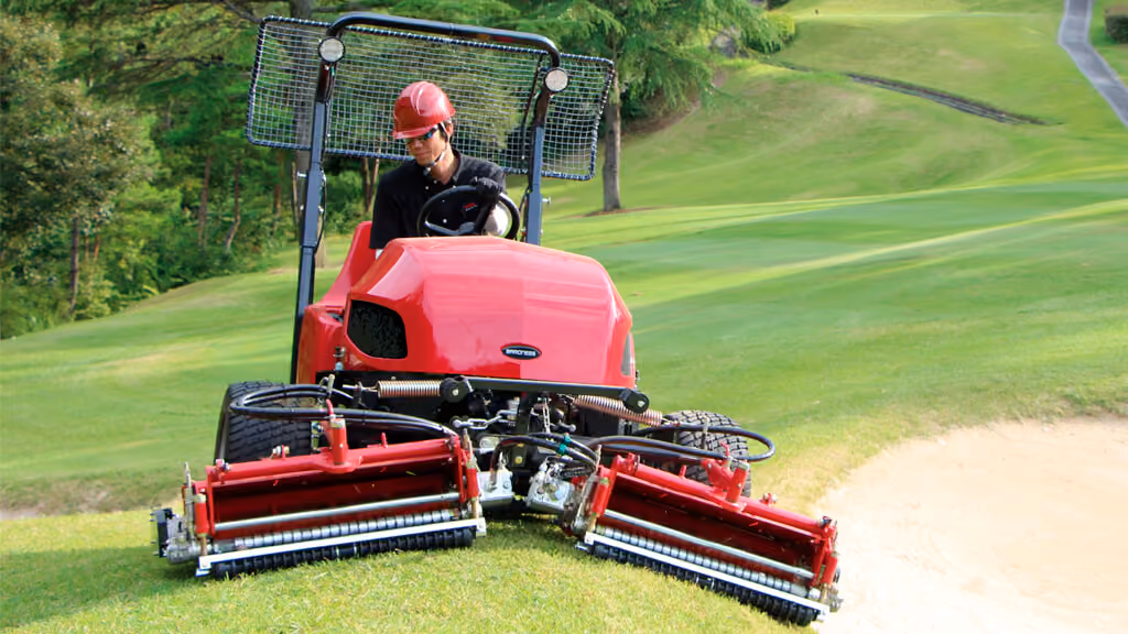Orange Kubota mower with cutting deck.