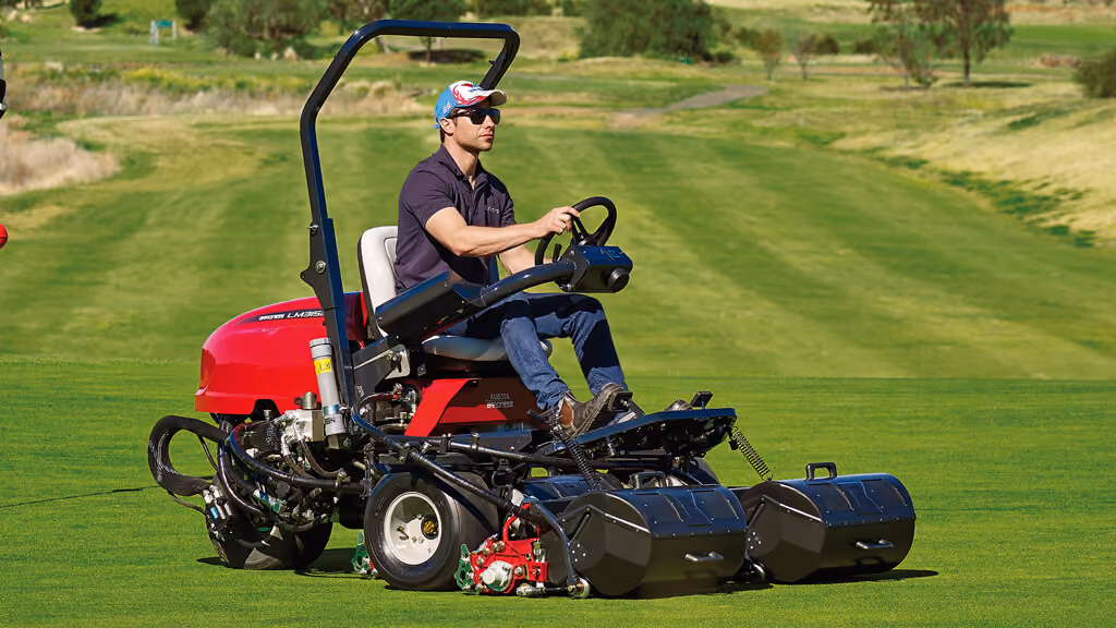 Orange Kubota mower with cutting deck.