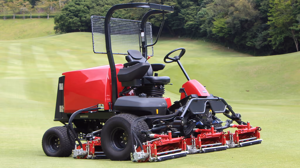 Orange Kubota mower with cutting deck.