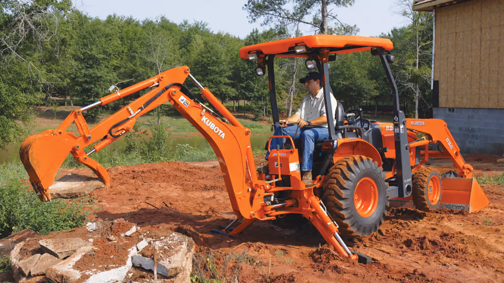 Orange Kubota tractor with roll-over protection.