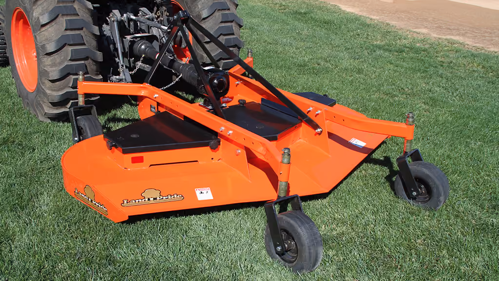 Orange Kubota mower with cutting deck.