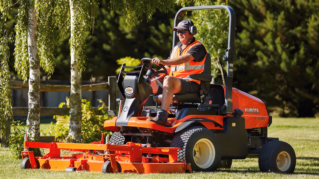 Orange Kubota mower with cutting deck.