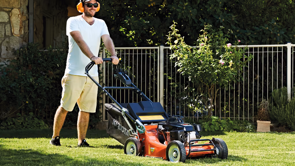 Orange Kubota mower with cutting deck.