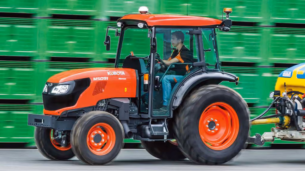 Orange Kubota tractor with roll-over protection.