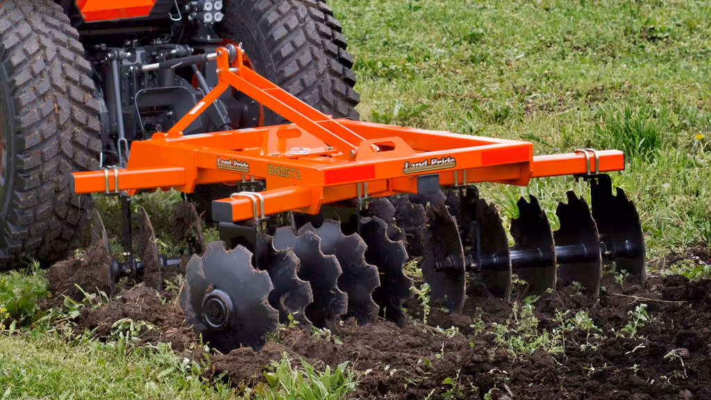 Orange disc harrow attachment with angled steel discs.