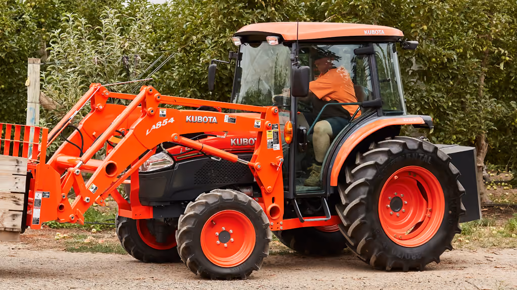 Orange Kubota tractor with roll-over protection.