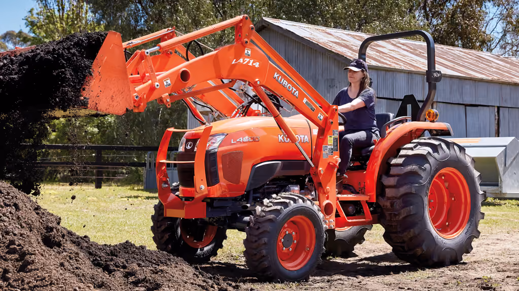 Orange Kubota tractor with roll-over protection.