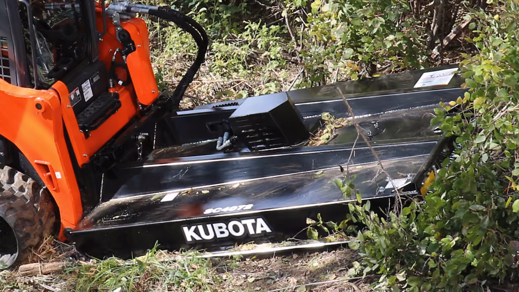 Orange rotary cutter attachment for pasture and field mowing.
