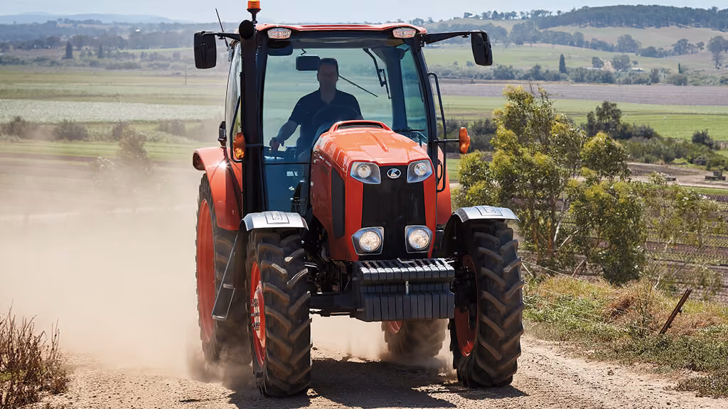Orange Kubota tractor with roll-over protection.