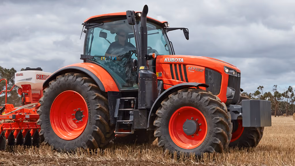 Orange Kubota tractor with roll-over protection.