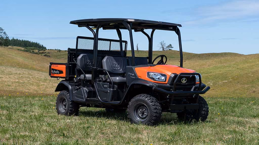 Orange Kubota utility vehicle with open cargo tray.