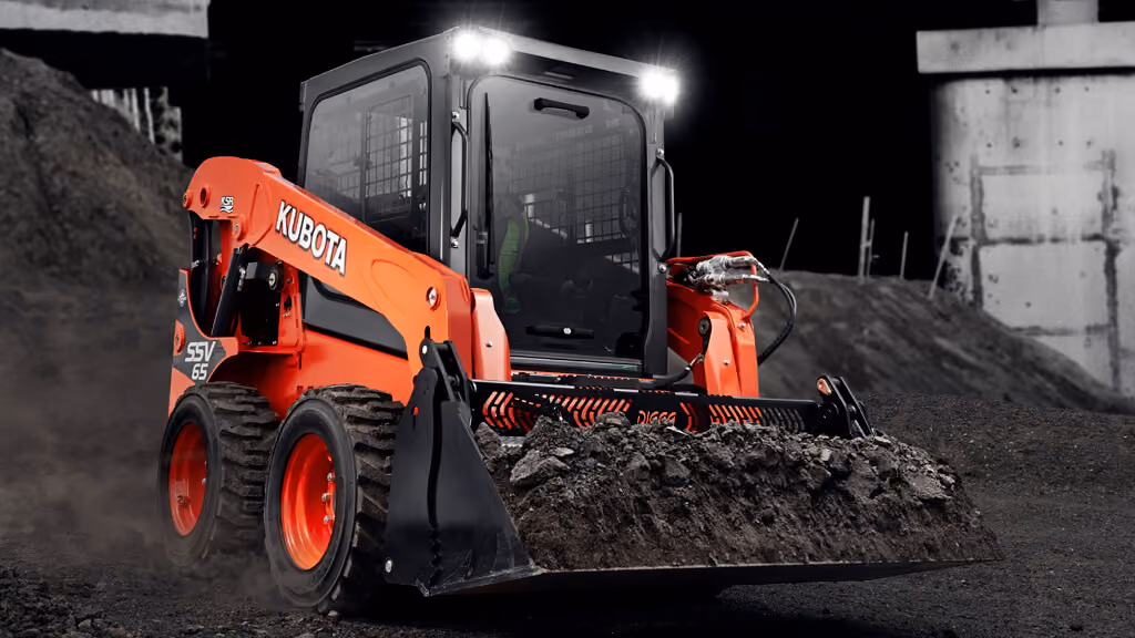 Orange Kubota skid steer loader with front bucket.