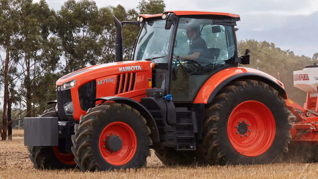 Orange Kubota tractor with roll-over protection.